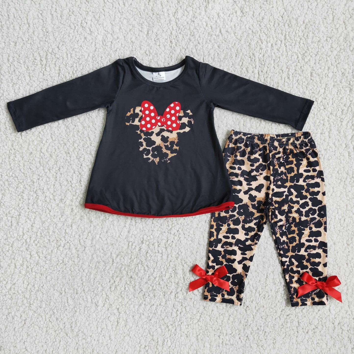 girl black long sleeve top leopard pants outfit with bow