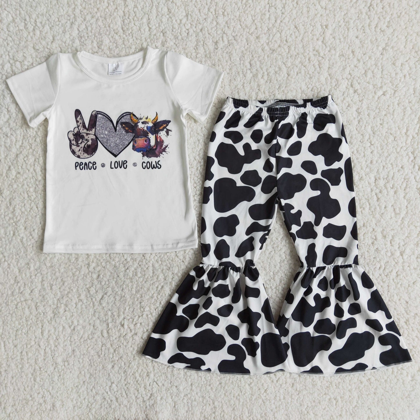 girl white  short sleeve top and milk cow print bell pants suit