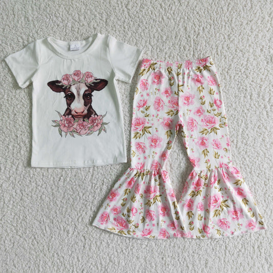girl white top with cow print and flowers bell pants outfit for spring