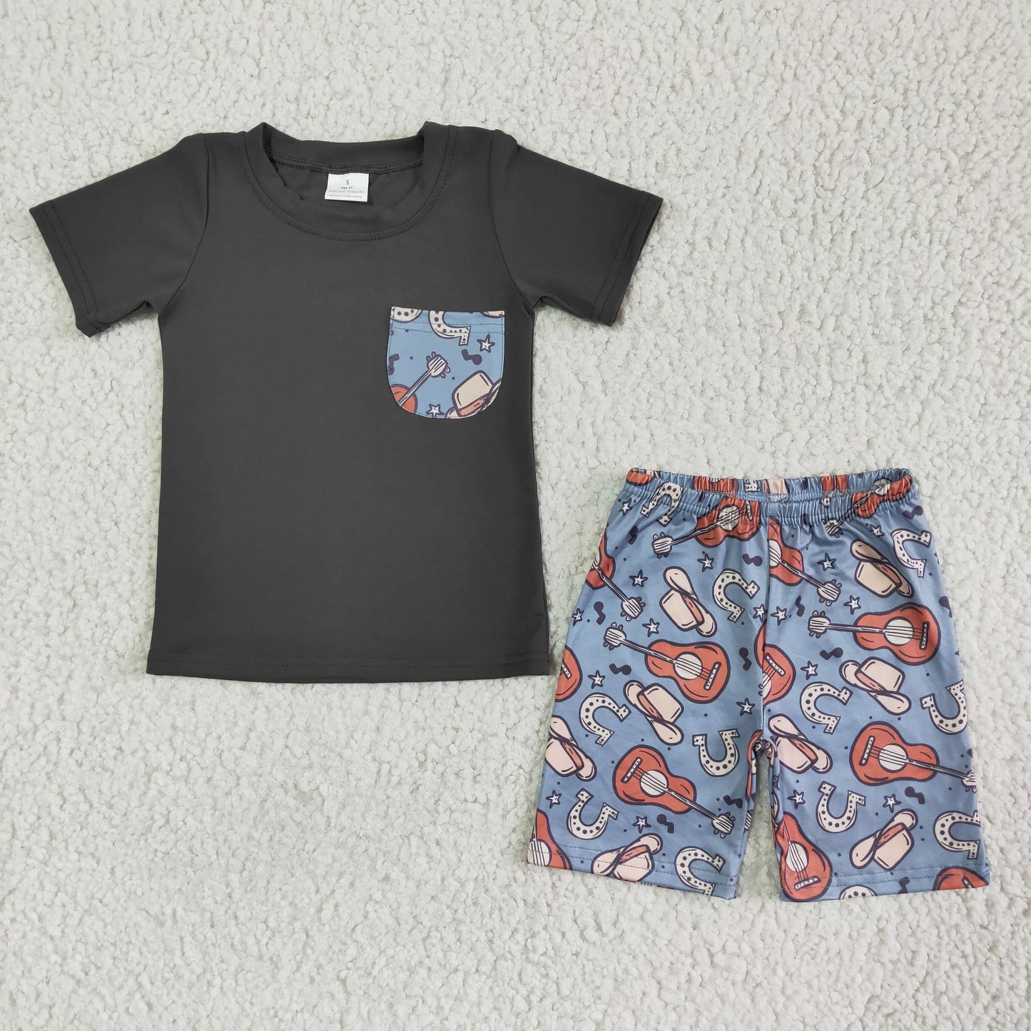 boy summer outfit with black short sleeve shirt and gitar print shorts