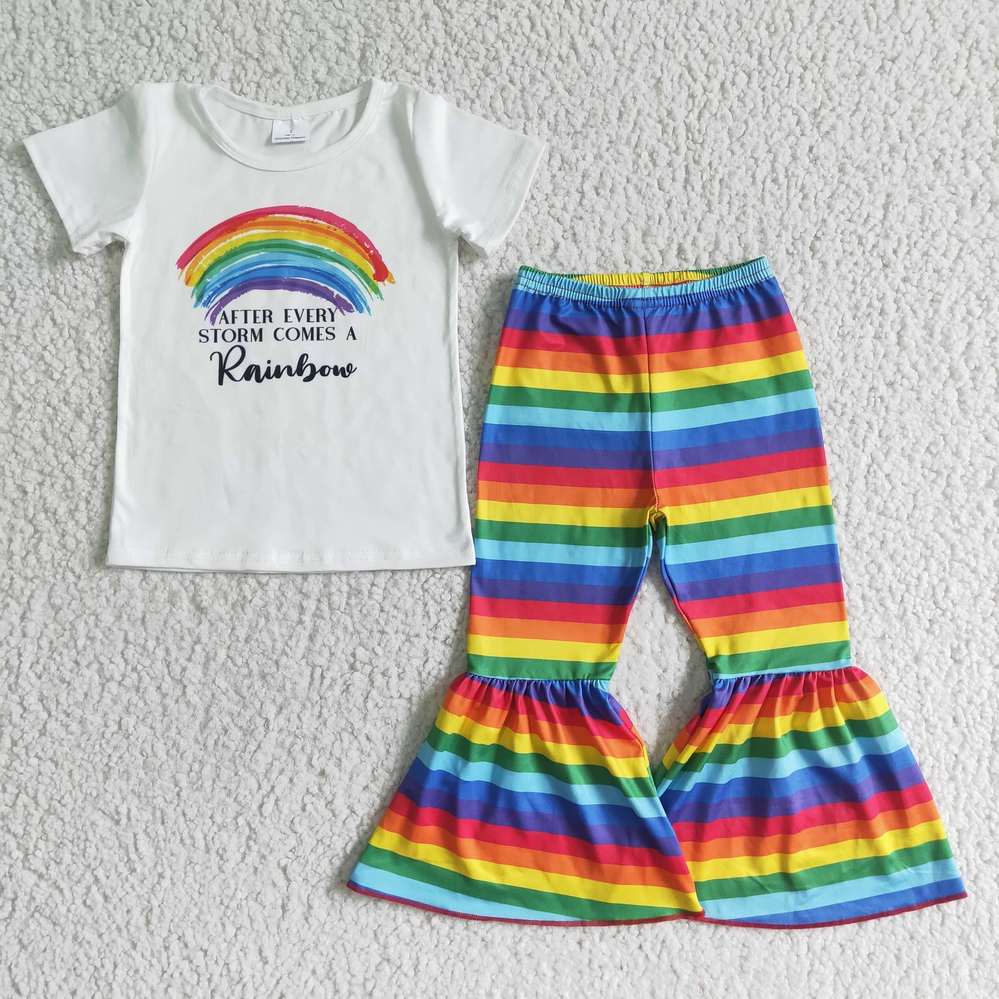 girl white short sleeve top and colorful stripes flare pants outfit